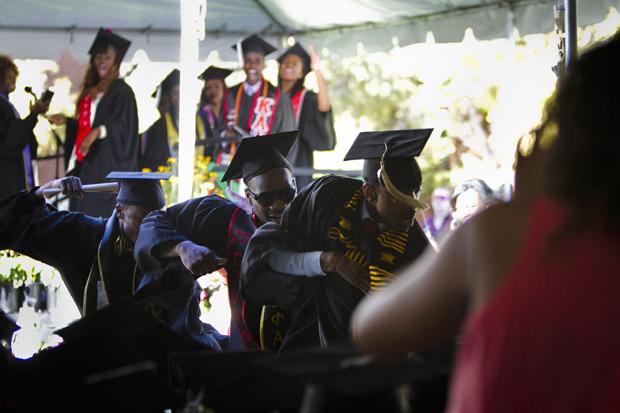 Enthused graduates dance in celebration of receiving their diplomas during the Black graduation ceremony, Sunday. Photo credit by Charlie Kaijo/Senior Staff