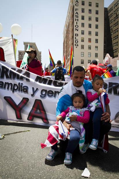 Luis Arredondo and his daughters, Alison and Mylin, at the May Day rally at Olympic Boulevard and Broadway Street. Photo credit by Charlie Kaijo / Senior Photographer