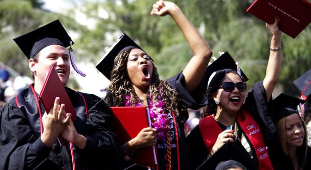 CSUN graduates celebrate getting their diplomas during the Art, Media and Communications graduation held at the Oviatt Library lawn, Wednesday. Photo credit: Loren Townsley / Editor in Chief