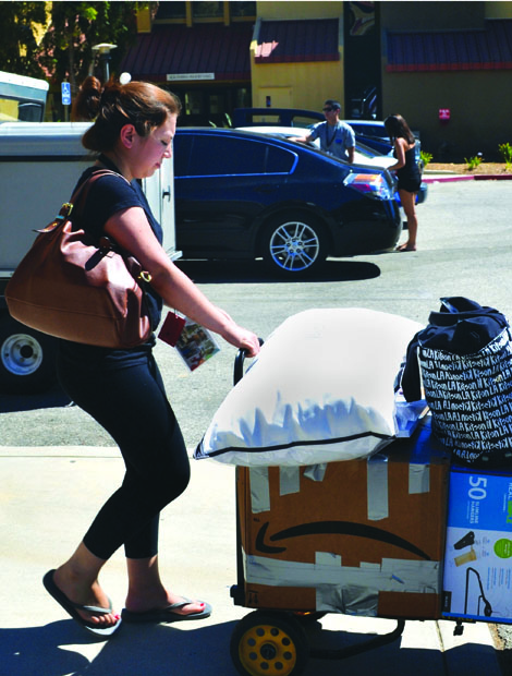 Jessica Contreras, 19, a sophomore communications major, borrows a dolly from housing to bring her belongings to her new dorm room. CSUN students were allowed to move in Saturday Aug. 24. Photo credit: Victoria Becerril / Daily Sundial