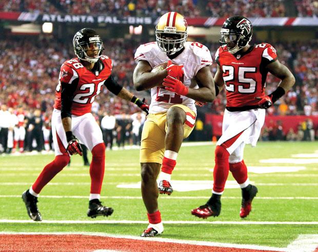 San Francisco 49ers runningback Frank Gore splits two Atlanta Falcons defensive backs for a touchdown in last year's NFC championship game. Photo credit: MCT