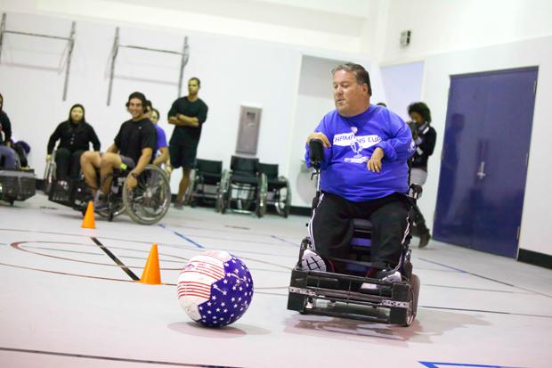 Steve Everett, the western regional director of the United States Power Soccer Association, shows kinesiology students how to spin-kick during a clinic in Redwood Hall. Photo credit: Loren Townsley / Daily Sundial