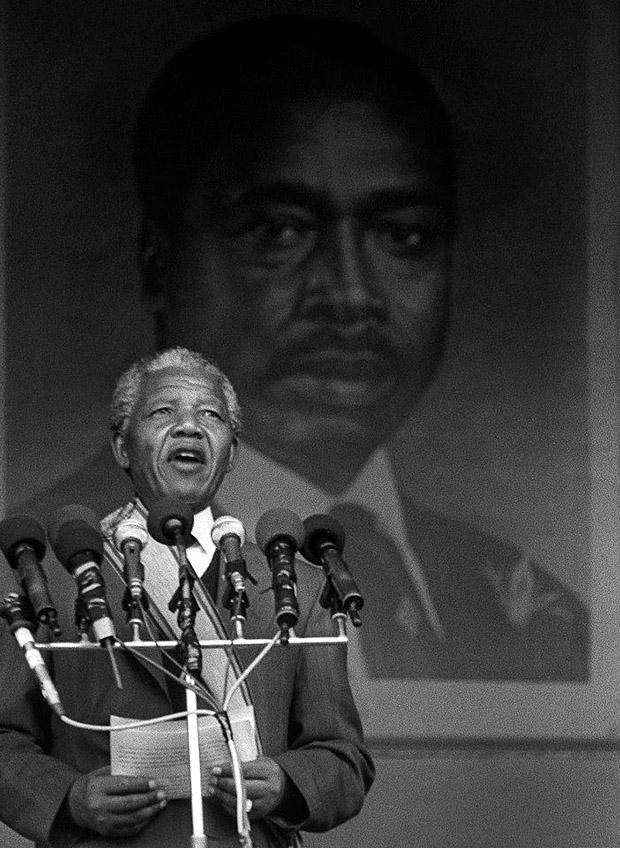 Nelson Mandela, in front of a giant portrait of Kenyan president Moi, speaks to a large crowd at Nairobi's Kasarani Stadium, during a tour of African countries after his release from prison in 1990. Photo credit: David Blumenkrantz / Contributor