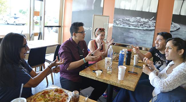 From left to right: Senior deaf studies majors Jaspreet Ghotra, president of the Deaf Students Association, Michelle Jones, 24, treasurer of the DSA, Emily Tierman, 22, Juan Ramos, 24, and Valerie Avila, 23, communicate in sign language during a fundraiser for the DSA on Tuesday, Sept. 30. at PizzaRev in Northridge, Calif. Photo Credit: Alex Vejar/ The Sundial