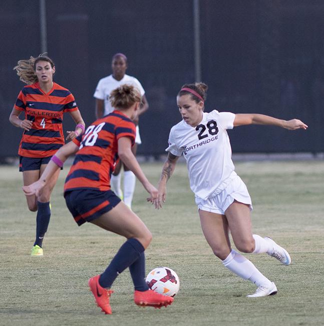 Junior Lyndsey Preston looks for a way past Cal State Fullerton's Colleen Ortega during the Matadors' match on Oct. 19, 2014. The Matadors fell to the Titans, 1-0, suffering their first loss in the Big West Conference. Photo Credit: Trevor Stamp/ Senior Photographer