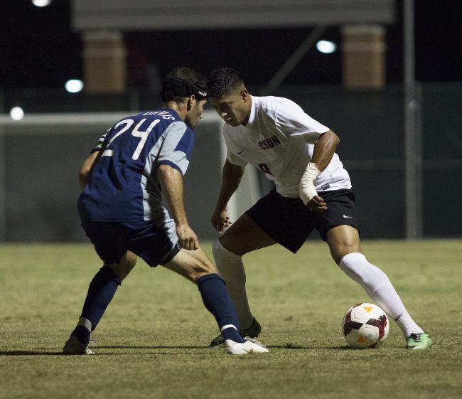 Redshirt senior Edwin Rivasgoes head-to-head with UC Davis' Brian Ford in Saturday night's matchup. After a tense matach that bled into overtime, the Matadors iied the Aggies 0-0. Photo credit: Trevor Stamp