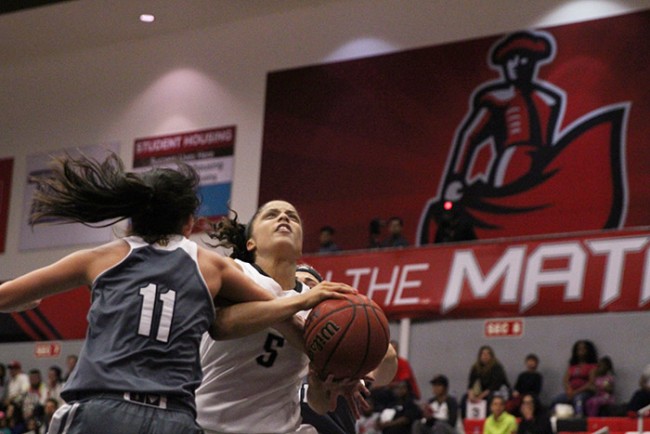 Senior Ashlee Guay gets fouled on her way to the hoop during the second half of the Matadors' game against UC Irvine on Feb. 21, 2015. Guay led the way with 18 points. (Trevor Stamp / Multimedia Editor)