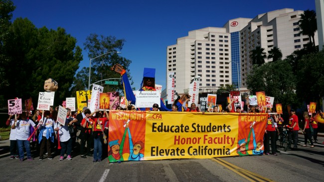 Members and supporters of the California Faculty Association rally through downtown Long Beach on Nov. 17, 2015 for better wages. Photo Credit: Nicollette Ashtiani
