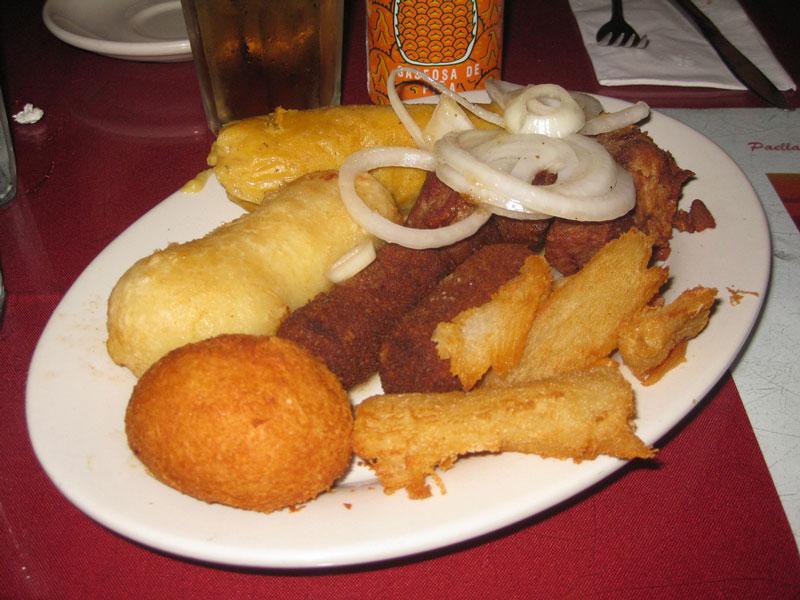 The Versailles Sampler Plate ($16.95) with ham croquettes, stuffed and fried yucca served with garlic, and a pork tamale. Photo Credit: Yazmin Cruz/ Staff Reporter