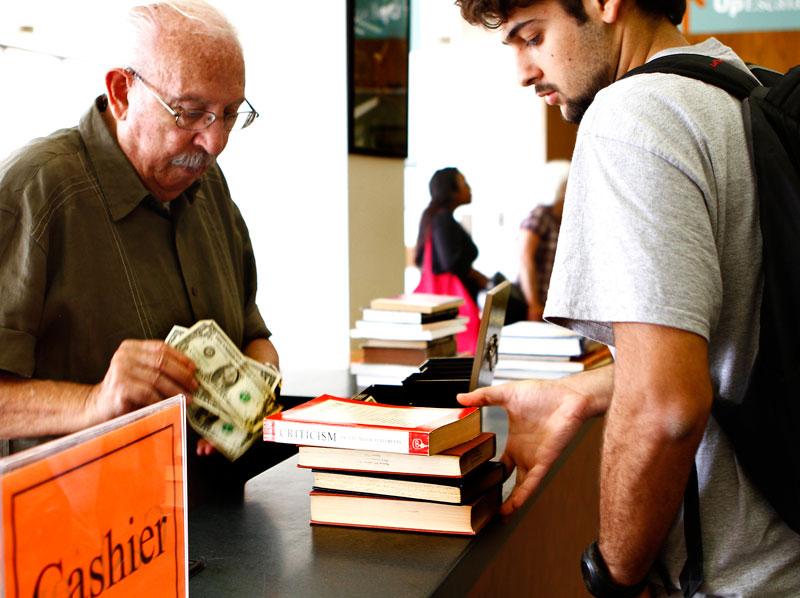 Joe Russo, Sherman of the gift book area sells books to Abraham Odabachian, 19, phylosophy major sophomore at the book sale event at the Oviatt Library on Tuesday. Photo Credit: Natalia Bereznyuk / Staff Photographer 