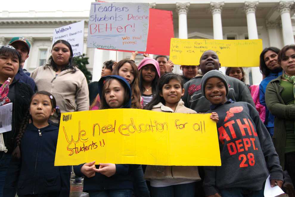 Students and teachers from Fred T. Korematsu Discovery Academy in Oakland, Calif. stand in front of the Capitol building in Sacramento.  Last year KDA lost 11 teachers to budget cuts and they are afraid with more cuts to education more teachers may lose their jobs. Photo Credit: Ken Scarboro / Online Editor