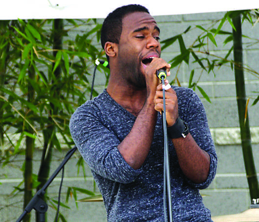 Vincent Coleman, 24, lead singer of Vas Defrans belts out a song during the noontime concert Thursday, April 21, 2011 at Plaza del Sol. Photo Credit: Katie Donahue / Contributing Photographer