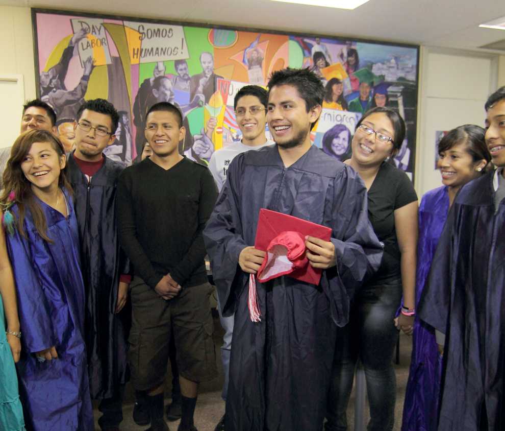 Mario Castillo stands with a red cap and blue gown to celebrate the passing of AB 131 with fellow interns at the Coalition for Humane Immigrant Rights of Los Angeles on September 2, 2011. The California Dream Act was signed into law Saturday by Gov. Jerry Brown. Simon Gambaryan / Daily Sundial