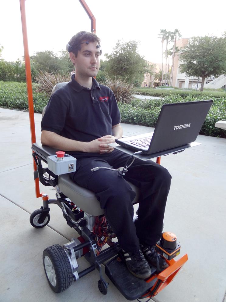 Mechanical engineering graduate student, Craig Euler, tests the movement and mechanical functions of a wheelchair using a brainwave helmet detector.  Katherine ONeill / Daily Sundial