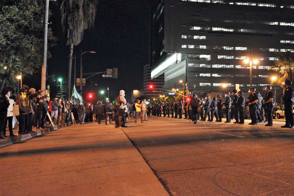Protestors and police face-off on First Street at nearly 5:00 a.m. Monday. Polie promise they would not make arrests inside the camp, requesting protestors clear the streets. Photo Credit: Ken Scarboro / Editor in chief