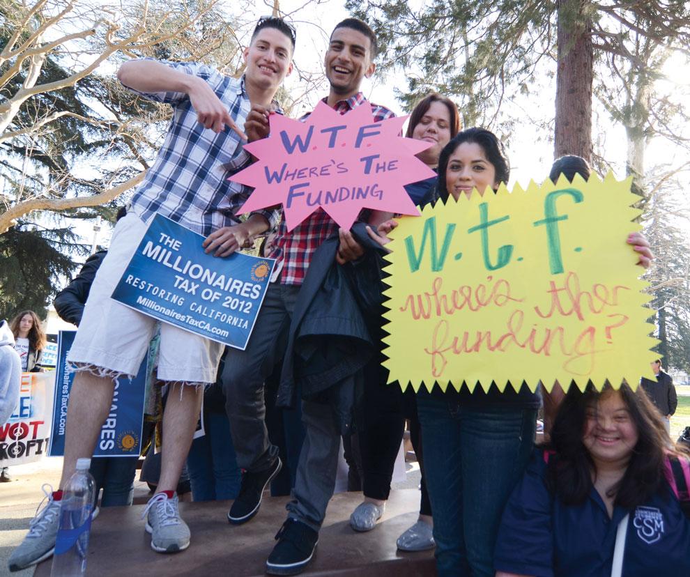 Standing+on+tables+and+chanting+to+build+energy%2C+students+from+College+of+San+Mateo+display+their+signs.+College+of+San+Mateo+was+one+of+many+community+colleges+who+gathered+with+other+California+higher+education+students+to+march+on+the+Capitol.+Photo+credit%3A+Ken+Scarboro+%2F+Editor+in+chief