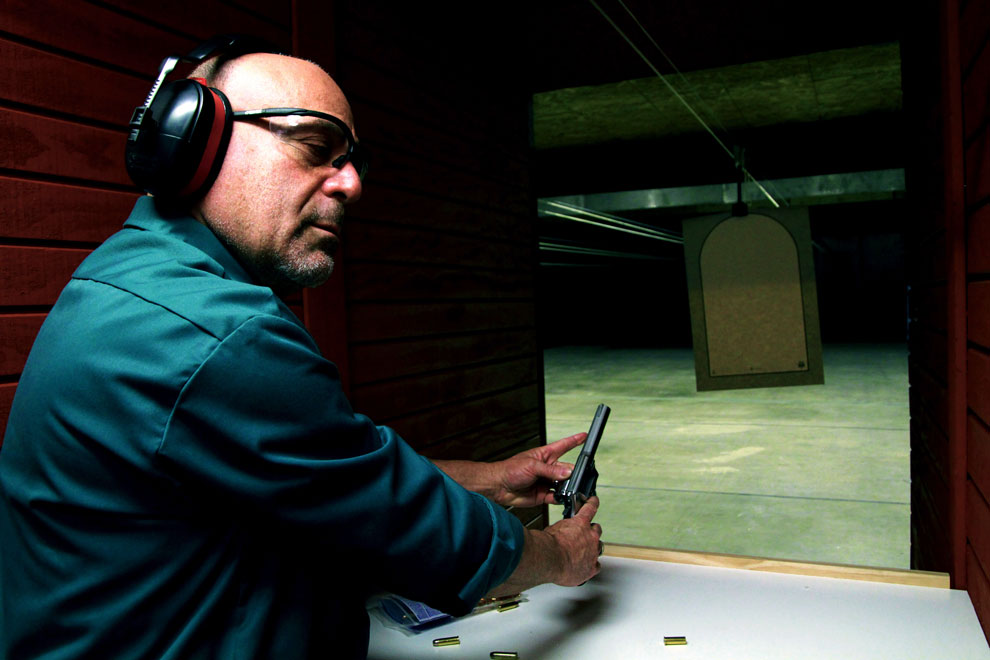 Steve Trager, owner of the Green Zone, demonstrates proper gun handling. We come from the classroom. We spend a good couple of hours where we run through all of the safety rules. We practice. Our classes are interactive. I ask questions of you when Im done, he said. Photo credit: Charlie Kaijo / Daily Sundial