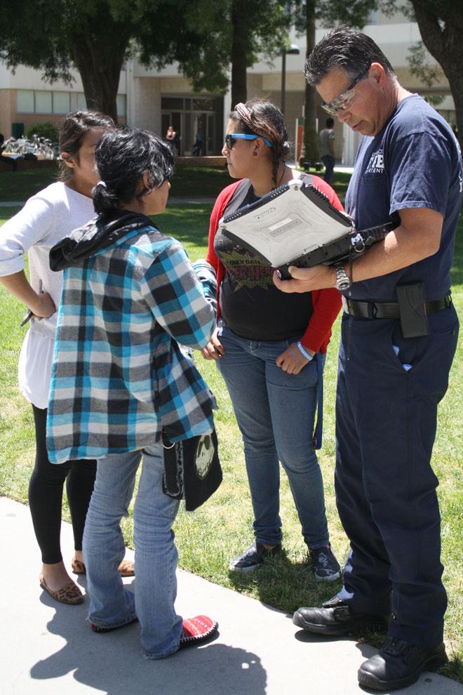 Raiza Arias, 18, double-major in theater and anthropology, gives her information to an officer after collapsing on Monday. Arias is one of the CSUN students who is currently on a hunger strike. Photo credit: Mariela Molina / Photo Editor