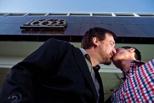 Jerome Jerry Reiter leans in to kiss his fiance, Ruben Valasquez, in front of the St. Thomas Aquinas Center for gay curing in Encino. Reiter spent more than 20 years in various conversion therapies since age 16. He said he entered the therapy in fear his parents would disapprove of his same-sex attraction. They are currently engaged and awaiting the Supreme Courts decision to see the Proposition 8 case. Photo credit: Charlie Kaijo / Assistant Photo Editor