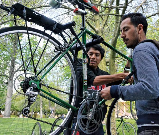 Carlos Sapon (left), 18, history major and Esteban Rivas, 25, political science major are a part of CSUN Bike Collective. A.S. provides the club with $700 so that they can have weekly bike clinics and fix CSUN students bikes for free. Photo credit: John Saringo-Rodriguez / Daily Sundial