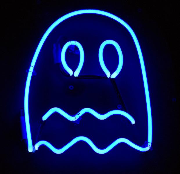A glowing neon Ghost from Pac-Man hangs above the entrance. It fit's the motif outside and pays homage to the video game that exploded an industry.