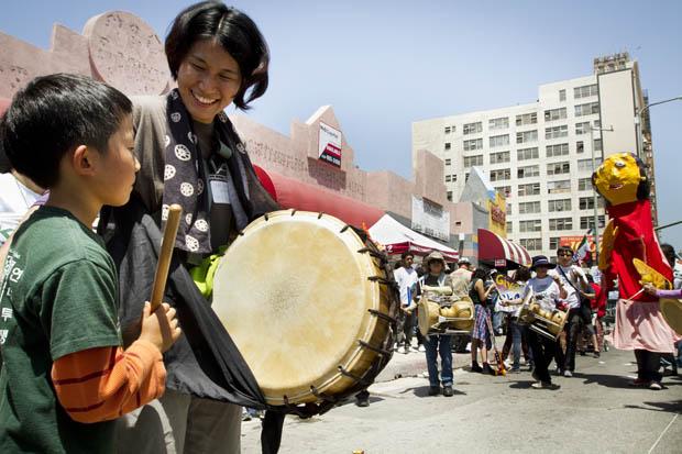 Members of the Koreatown Immigrant Workers Alliance participate in a rally on the corner of Olympic Boulevard and Broadway Street. Photo credit by Charlie Kaijo / Senior Photographer