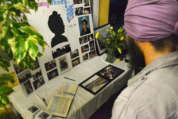 A memorial was held for Jusdeep "Peace" Sethi, 20, junior interdisciplinary major at a Sikh temple in Pacoima on Tuesday, August 13. Family and friends look at a photo collage before entering the temple. Photo credit: John Saringo-Rodriguez / Photo Editor