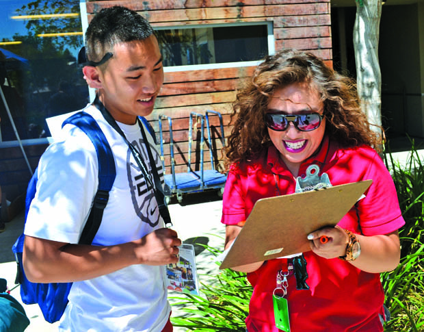 Muaj Hmoo Lee, 18, a chemistry major, is quickly introduced with his Resident Advisor as he moves into his new home at the freshmen dorms. Photo Credit: Victoria Becerril / Daily Sundial