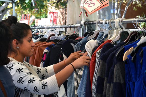 Jennifer Jimenez, 18, freshman, looks for the perfect hoodie to purchase at the Matador Mall located in the front of Bayramian Hall Monday. Photo credit: Victoria Becerril / Daily Sundial