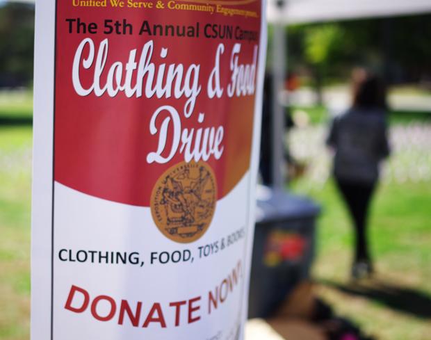 Unified We Serve tabled for the 5th Annual Clothing and Food Drive at the Oviatt Lawn Tuesday morning. Photo credit: Matthew Delgado