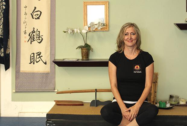 Martial arts master Helen Azalone Gordon, creator of “You Can Fight,” sits in her home studio. Gordon has been practicing martial arts for 20 years, and has recently translated her skills into a self-defense app for women on the go. Photo credit: Abigail Rondon / Daily Sundial