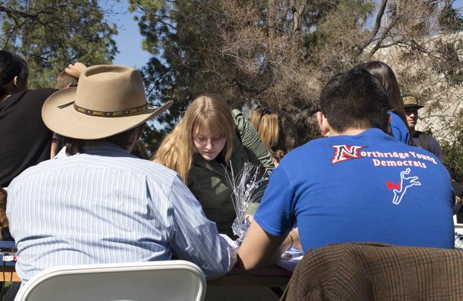 Christine Nation, 19, a deaf studies major, meets with the CSUN Young Democrats club during Meet the Clubs event on Tuesday on Bayramian Hall Lawn. Nation said she wants to join a club for the camaraderie. Photo credit: Trevor Stamp / Senior Photographer