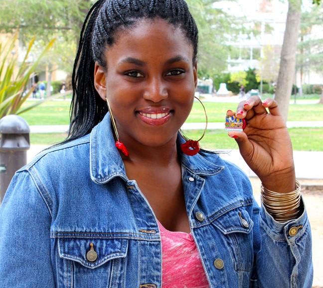 Precious Malumfashi, 26, shows the pin she received for participating on the Festival of Roses Parade on Jan. 1.