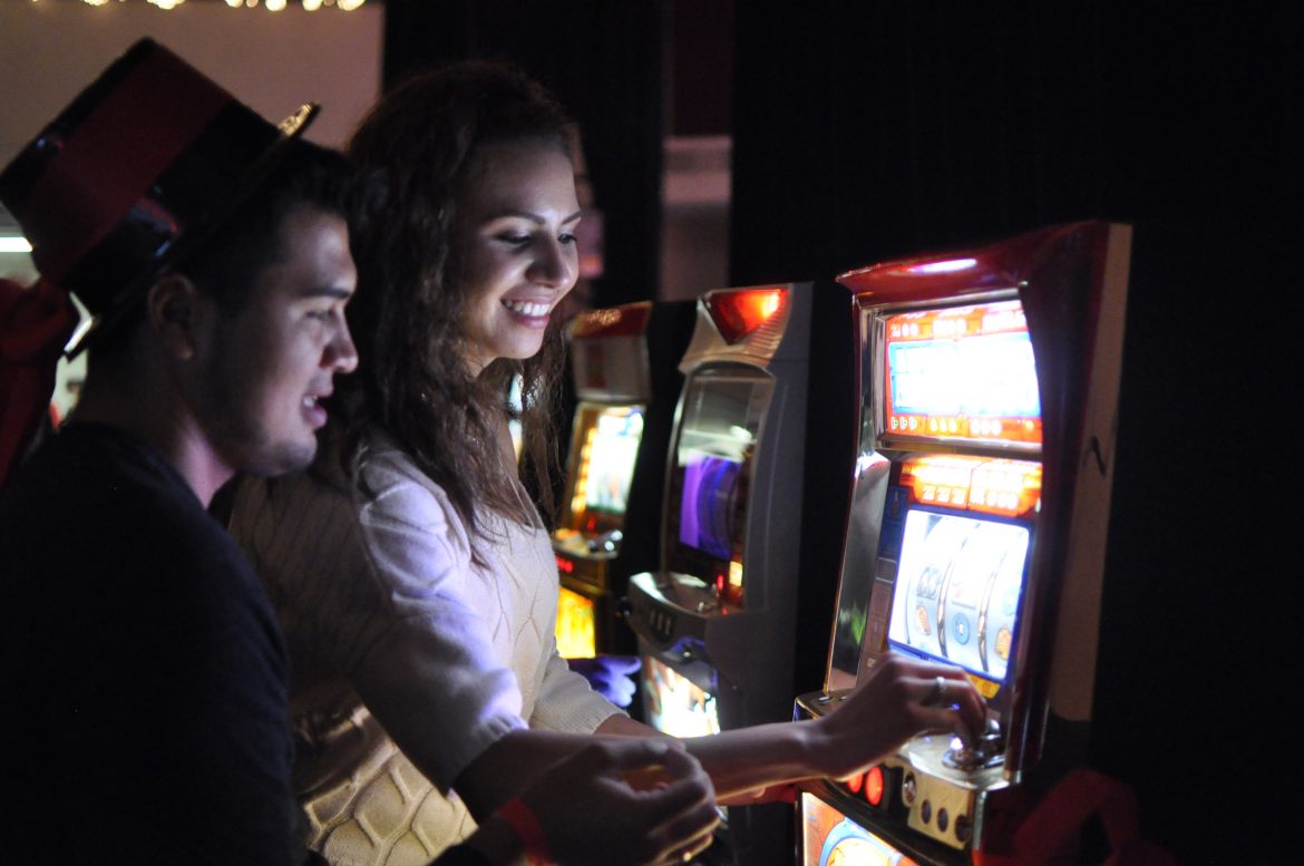  Eric Garcia, 22, CTVA senior, left, and Brenda Topete, 19, CDAC sophomore, right, playing the slot machine in the casino room at the Matador Nights on Friday, April 25, 2014 at the USU parking lot in Northridge, Calif. (Photo Credit: David J. Hawkins/Photo Editor)