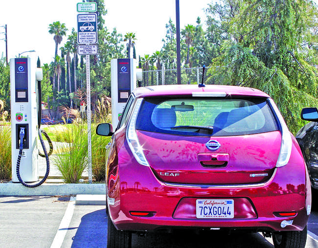 A Nissan LEAF uses one of the two charging stations located in the F5 parking lot, Apr. 21. They are the only fast-charge stations on campus and can charge a drive range between 60 to 80 miles in about 20 minutes. Photo Credit: Lucas Esposito / Daily Sundial