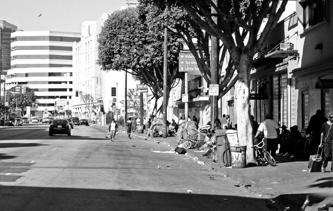 The+stark+contrast+between+the+affluent+businessmen+and+those+living+in+poverty+in+Los+Angeles+can+be+seen+literally+across+the+street+from+each+other.+Photo+credit%3A+David+J.+Hawkins%2FPhoto+Editor