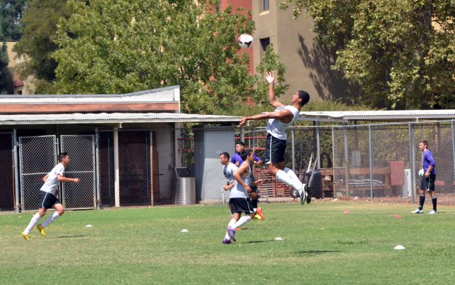 Gabe Robinson, sophomore, defender jumps for the ball in to take control of the play during the teams practice. Photo Credit: Vincent Nguyen/ The Sundial