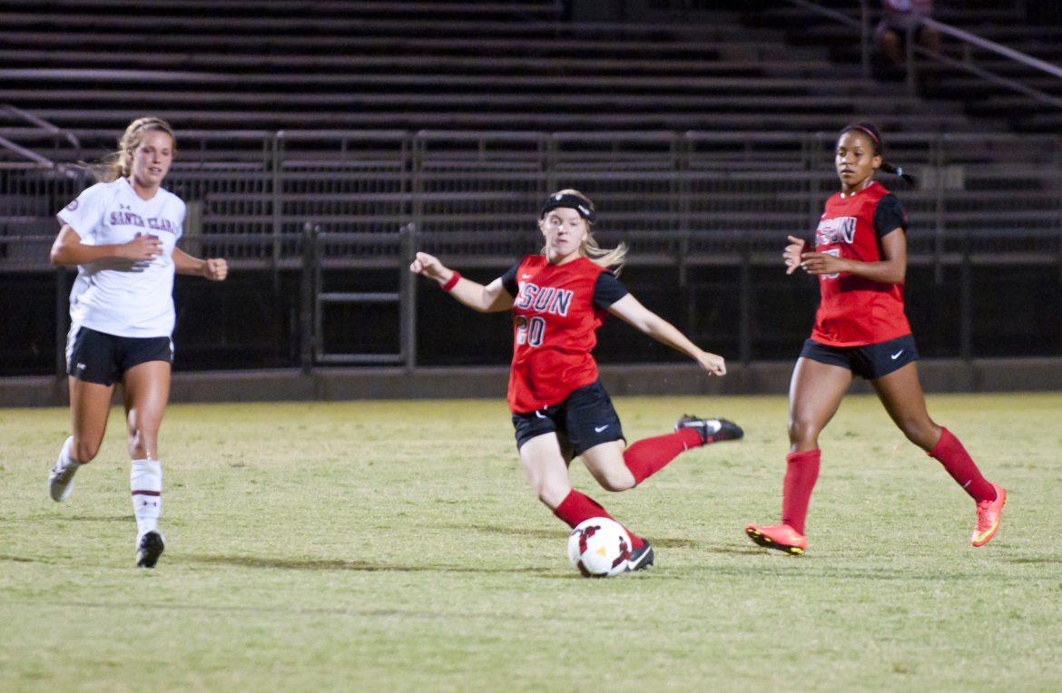 Matadors Kourtney Kutscher, center, tries to score as the Broncos midfielder Dani Weatherholt, left, races to the ball in the first half at the Matador Soccer Field on Friday, September 26, 2014 in Northridge, Calif. With the game resulting a 1-0 loss against the Santa Clara Broncos who proved to be a strong defensive team with a 5-4 record with no losses as the Matadors press on with several offensive plays despite the Broncos 5 saves the Matadors were unable to score. (Photo Credit: David J. Hawkins/The Sundial)