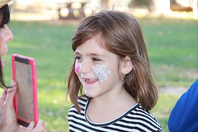 Mackenzie Penner, had her face painting done at the Family Fun Zone. The event welcomed children of CSUN staff and students. Face painting, a animal petting station, food, and games were offered to everyone who attended.  Photo Credit: Victoria Lopez/Contributor