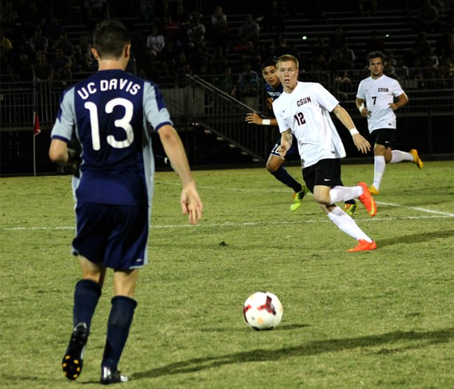 Matador, Shane Steffes, attempts to head off the ball as Aggie, Ian Palmer, prepares to pass the ball to a teammate on Saturday, Oct. 11. that ended in a 0-0 tie. Photo Credit: Leilani Keeping/ Contributor