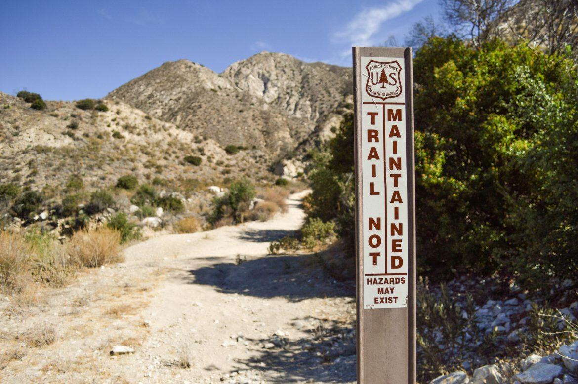 Condor Peak Trail in the Angeles National Forest is where Armando Villa hiked with the Zeta Mu chapter of Pi Kappa Phi. Signs warn hikers of hazards that the trail may have.