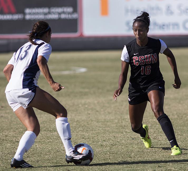 Senior Leandra Walker (right) gets into position to stop UC Davis Sienna Drizin from breaking into a run during the Matadors game on Oct. 16, 2014. The Matadors continued their Big Conference win streak with a 4-0 victory over the Aggies. Photo Credit: Trevor Stamp/ Senior Photographer