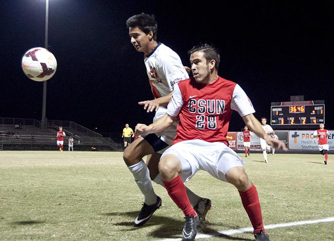 Matadors David Turcios, right, fights for the ball on the boundary line against Titans Jesse Vega, left, at the Matador Soccer Stadium on Wednesday, Nov. 5, in Northridge, Calif. The tie game prevented the Matadors from advancing to the playoffs that holds the Big West Tournament. Photo Credit: David J. Hawkins/ The Sundial