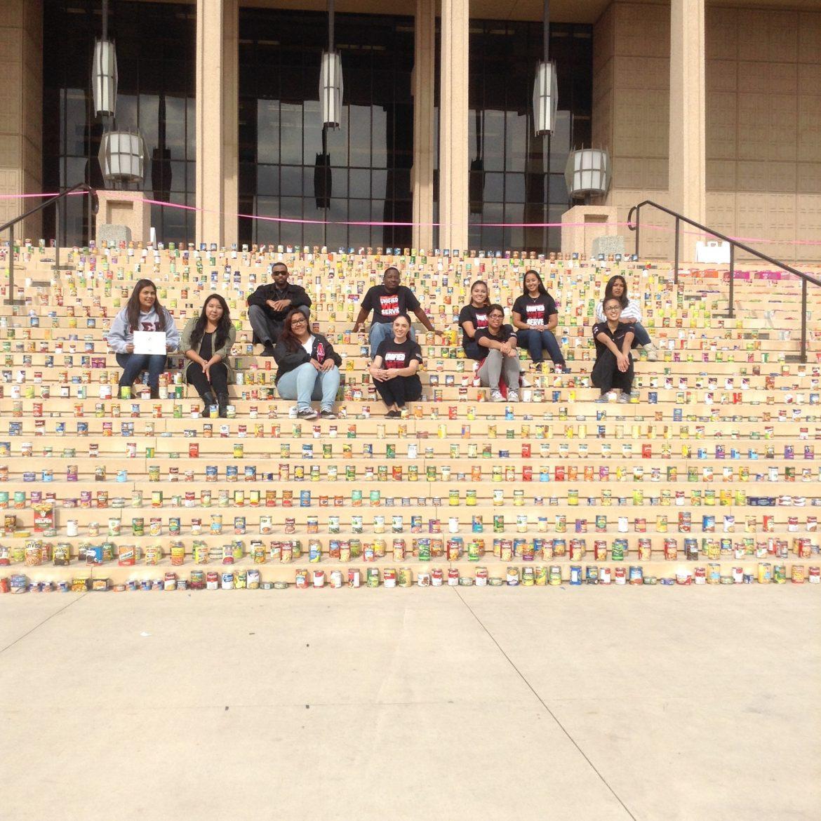 Students from the Unified We Serve student volunteer program at California State University, Northridge, are shown with donations in front of the Oviatt Library on Thursday, Nov. 13, 2014.