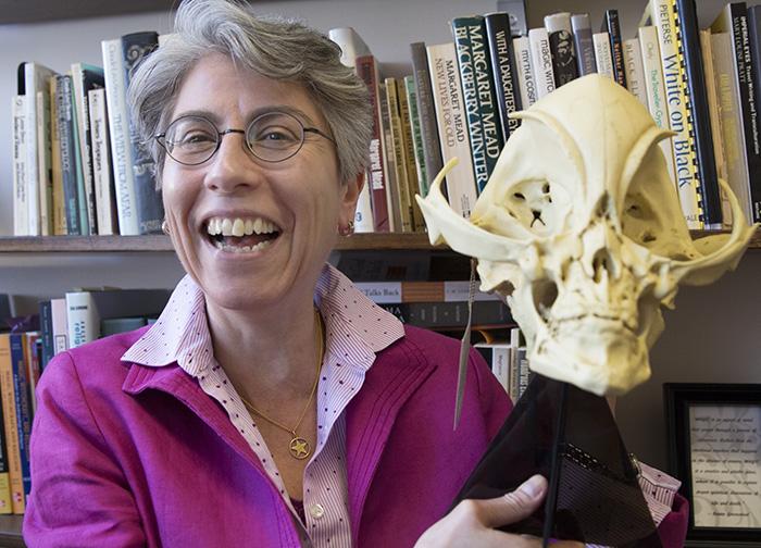 Anthropology professor Sabina Magliocco, shown here holding up a mock Alien Grey skull, was featured on History Channels Ancient Aliens, lending an expert voice to the show. (Trevor Stamp / Multimedia Editor)
