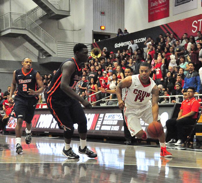 Sophomore guard Aaron Parks drives past a Cal State Fullerton defender in the closing seconds of an 82-72 CSUN victory at the Matadome on Feb. 26, 2015. Photo Credit: Andrew Martinez / Editor-in-Chief