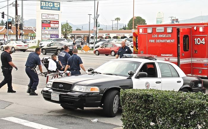 Officers load suspect into fire truck after police pursuit from Sherwood Forrest to the intersection of Reseda Boulevard and Nordhoff Street on March 17. Leni Maiai/Sundial Contributor 