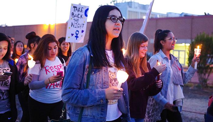 Students and community members participating in the 12th annual Take Back The Night, march and chant through campus to bring awareness about sexual violence and to end rape culture, on March 20. (Matthew Delgado / Staff Photographer)