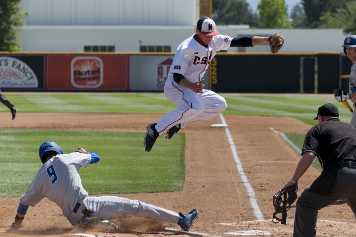 CSUN junior starting pitcher Calvin Copping, leaps over Gauchos senior second baseman Woody Woodward in an attempt to stop the first inning onslaught. (Photo credit: BHEphotos)