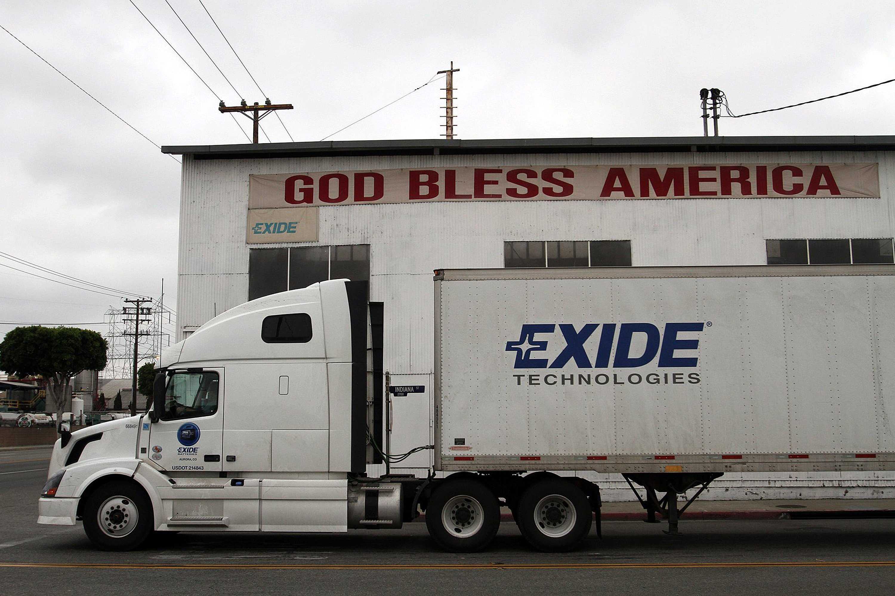 An Exide truck waits for traffic at Indiana Street and Bandini under patriotic sign at lead smelting company in Vernon, California, April 24, 2013. (Bob Chamberlin/Los Angeles Times/MCT)